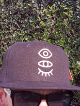 Load image into Gallery viewer, Black Snap-Back W/ Silver Eyevate Eyecon Emboidery
